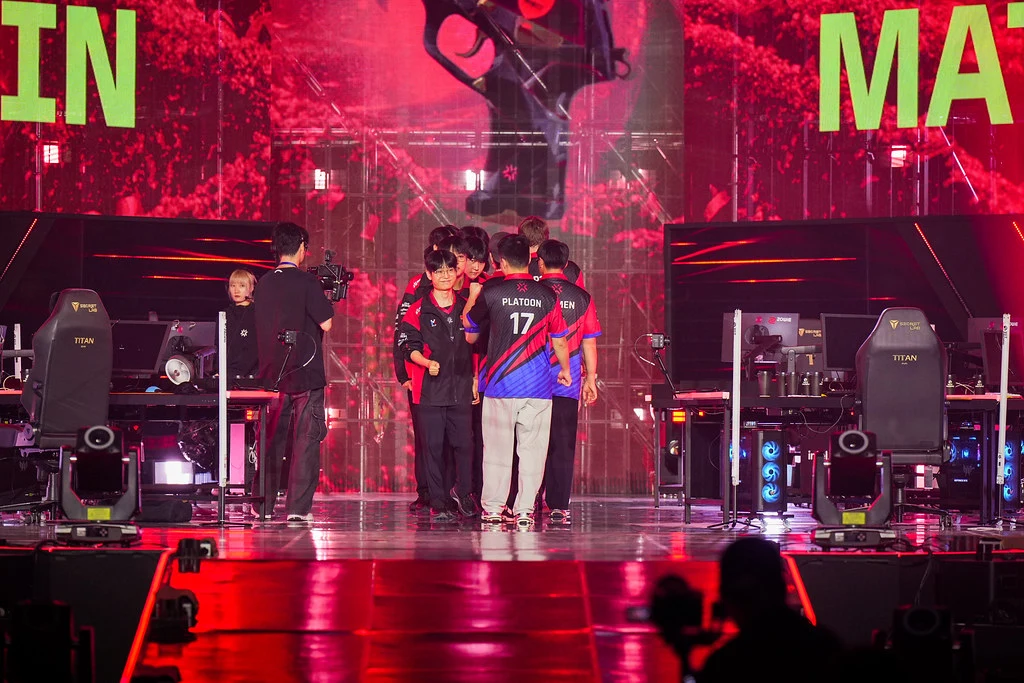 Global Esports players huddled together walking onto the Grand Final stage in Busan