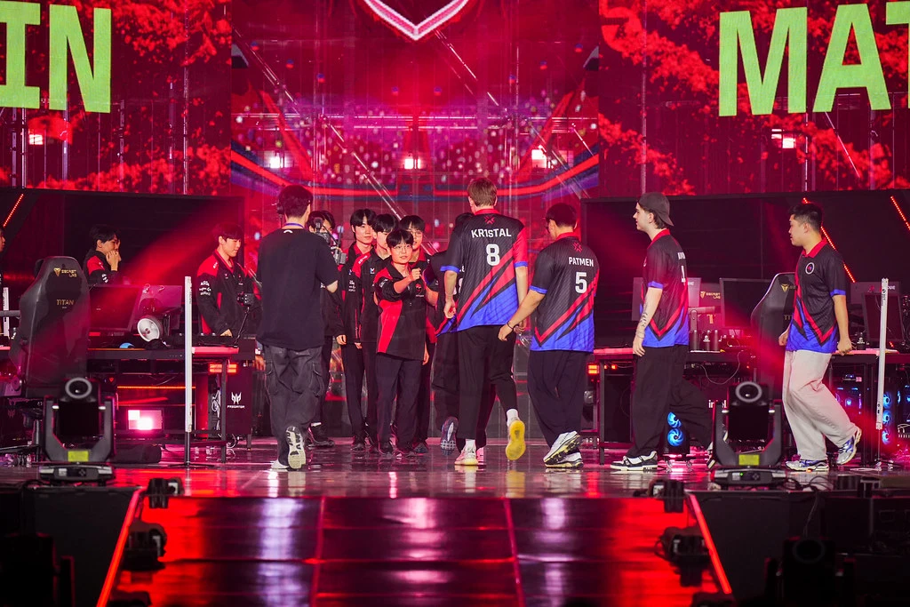 Global Esports players Kr1stal and PatMen fist-bumping teammates walking onto the Grand Final stage in Busan
